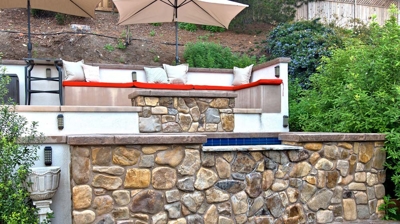 A spa with a fire pit and seating above it Photo